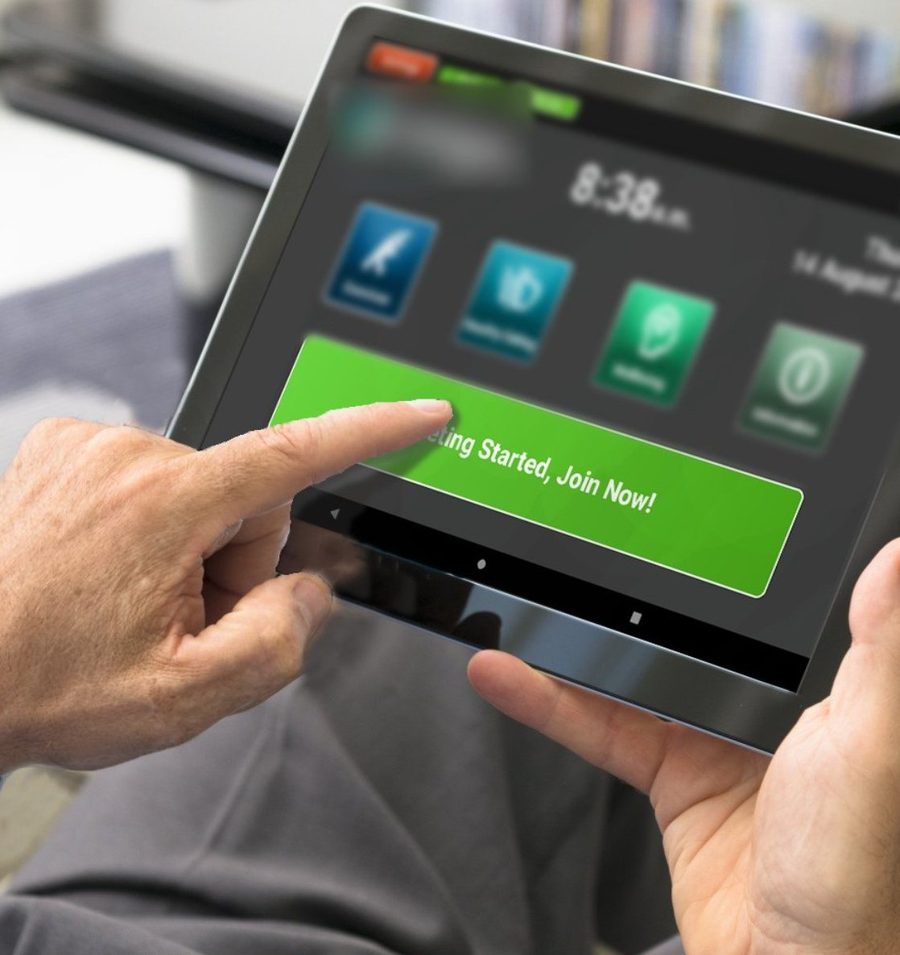 A patient tapping the large green Join Now button on the Tap to Connect tablet